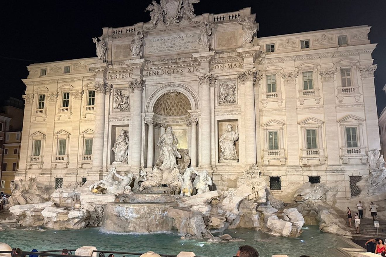 The Trevi Fountain floodlit at night on the evening tour